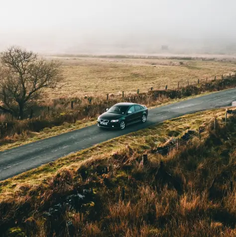 A car driving through a foggy road